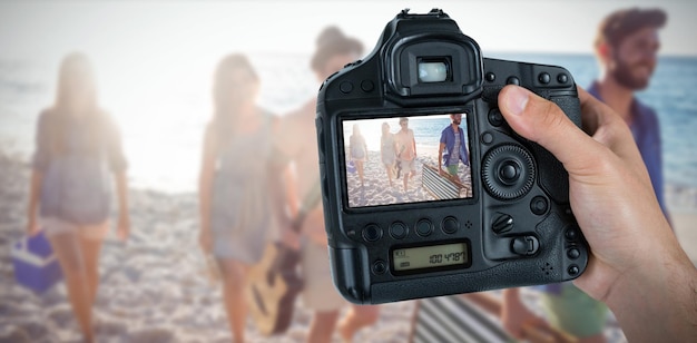 Composite image of cropped hand of photographer holding camera