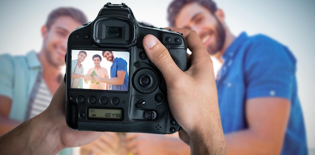 Composite image of cropped image of hands holding camera