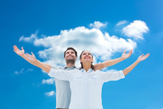 Composite image of cute couple standing with arms out