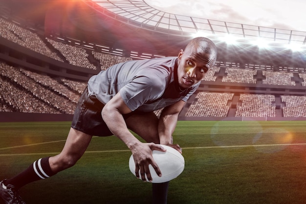 Composite image of determined sportsman looking away while playing rugby with 3d