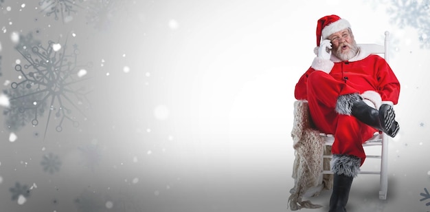 Composite image of excited santa claus talking on mobile phone