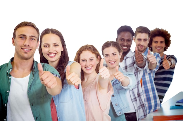 Composite image of fashion students showing thumbs up