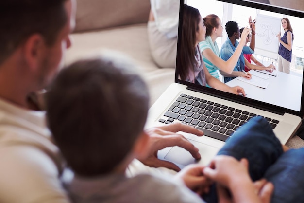 Composite image of father and son using laptop in house