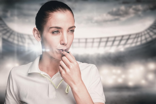 Composite image of female athlete blowing a whistle