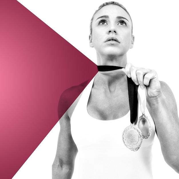 Composite image of female athlete holding medals