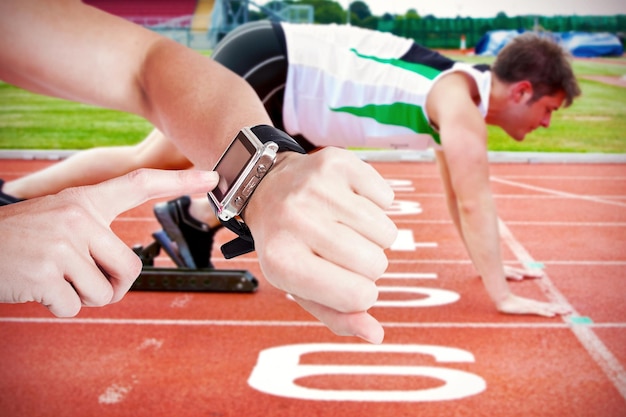 Composite image of female athlete using her smart watch