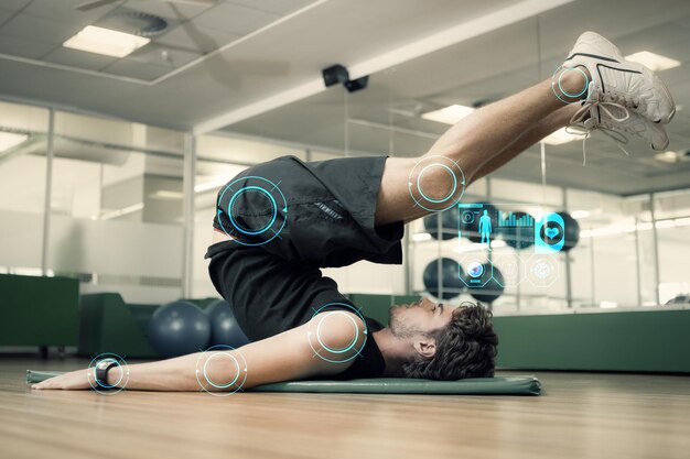 Composite image of fit man doing pilates in fitness studio