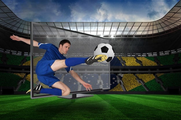 Composite image of football player kicking ball through tv against large football stadium with brasilian fans