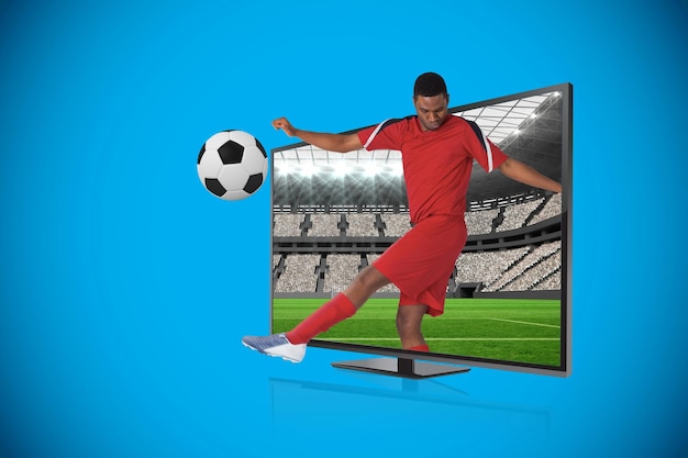 Composite image of football player kicking ball through tv against vast football stadium with fans in white