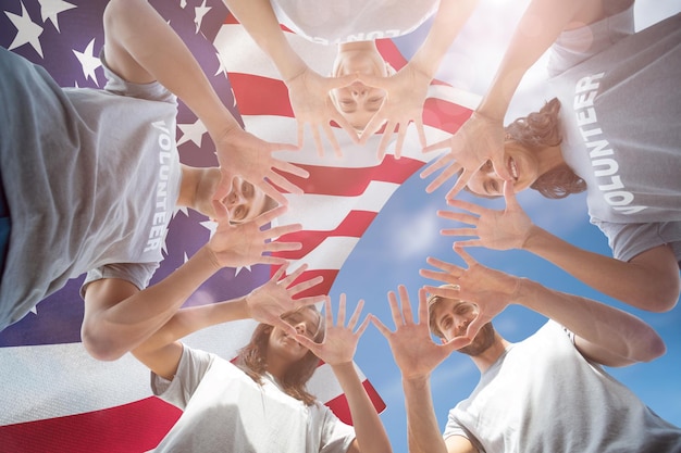 Composite image of friends putting their hands together