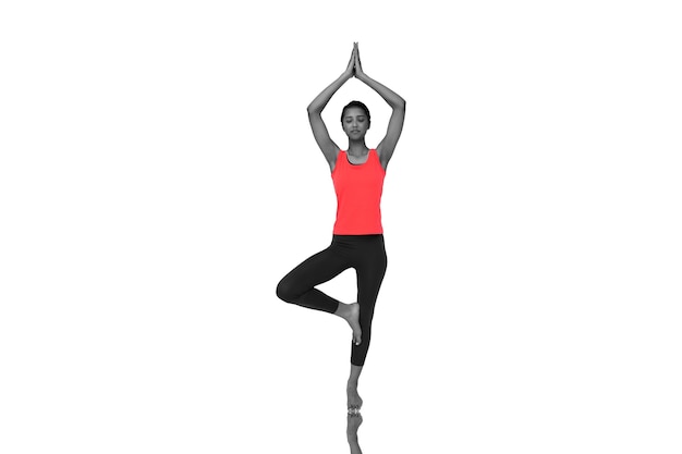 Composite image of full length of a fit woman standing in tree pose