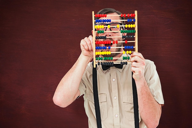 Composite image of geeky hipster holding an abacus