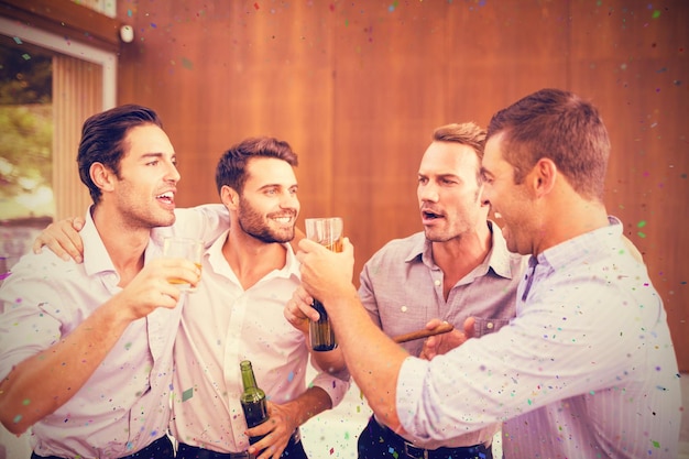 Composite image of group of young men having drinks