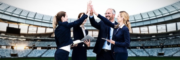 Composite image of happy business people giving high five
against white background