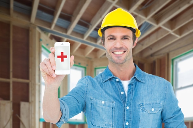 Composite image of happy carpenter showing smart phone