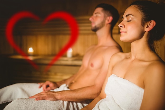 Composite image of happy couple enjoying the sauna together