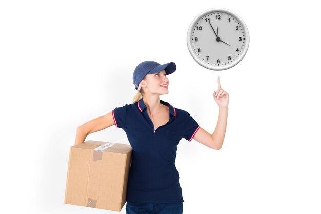 Composite image of happy delivery woman holding cardboard box and pointing up