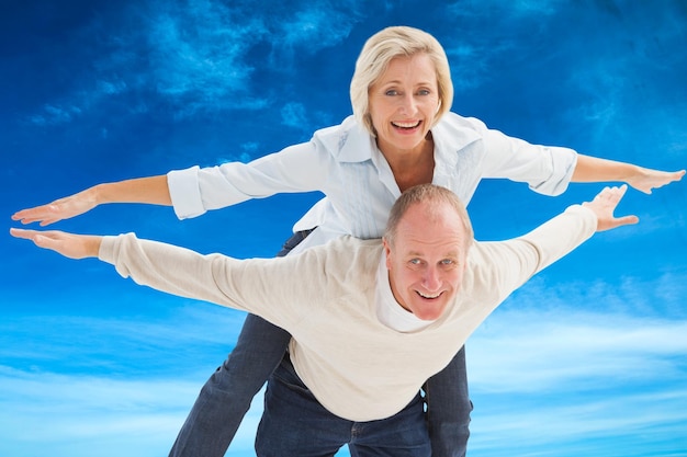 Composite image of happy mature couple having fun