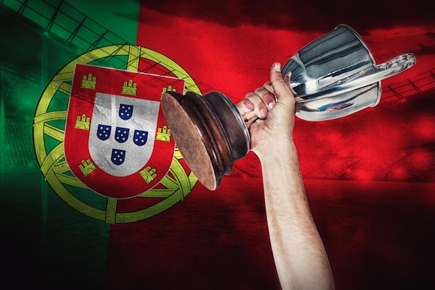 Composite image of happy rugby player holding trophy