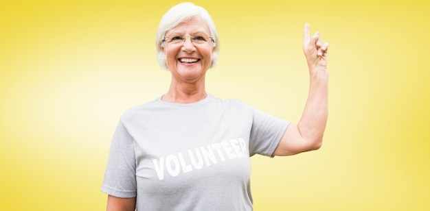 Composite image of happy volunteer grandmother with thumbs up