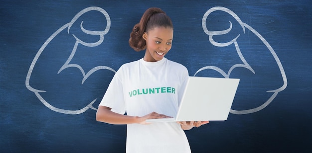 Composite image of happy volunteer using laptop