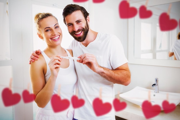 Composite image of hearts hanging on a line