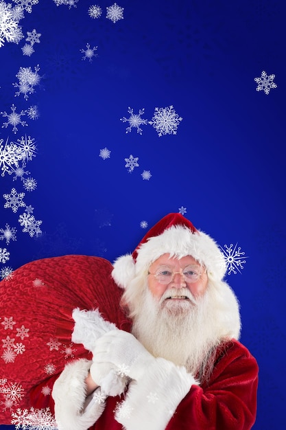 Composite image of jolly santa carries his sack