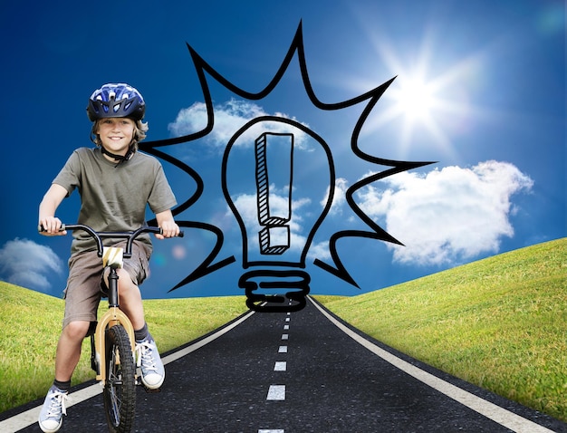 Composite image of little boy with his bike during the summer in a park