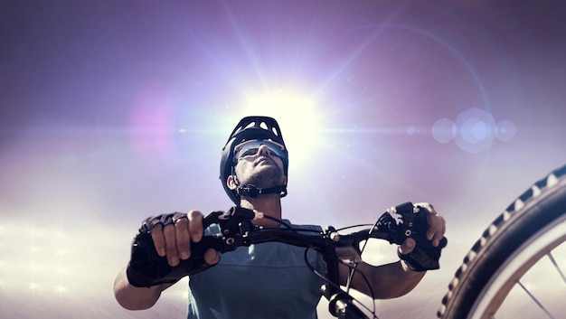 Composite image of man cycling with mountain bike