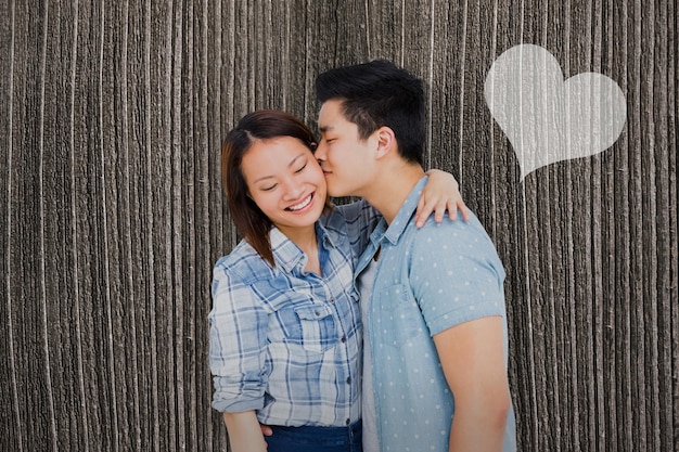 Composite image of man kissing happy woman