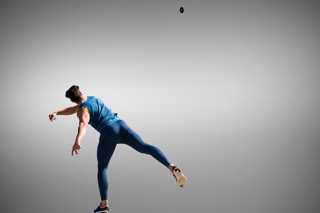 Composite image of man throwing discus against white background