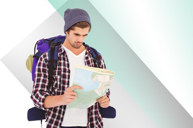 Composite image of man with luggage looking in map