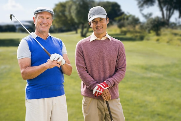 Composite image of men holding golf club