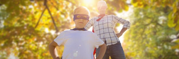 Composite image of mother and son pretending to be superhero