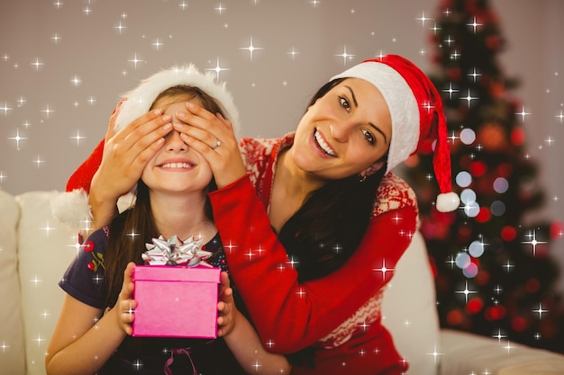 Photo composite image of mother surprising her daughter with christmas gift