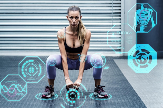 Composite image of a muscular woman lifting kettlebells