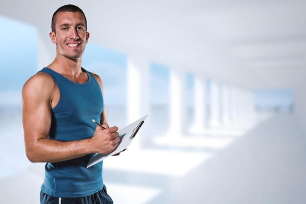 Composite image of portrait of confident sports coach writing on clipboard