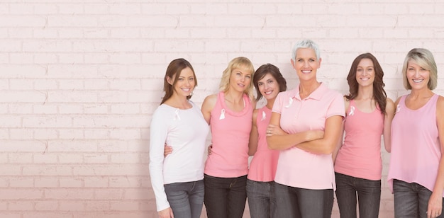 Composite image of portrait of confident women supporting breast cancer awareness