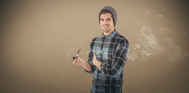 Composite image of portrait of happy man holding smoking pipe