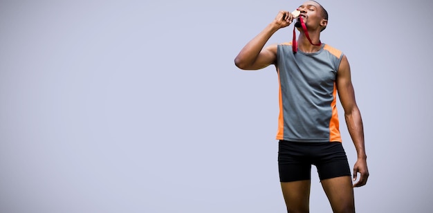 Photo composite image of portrait of happy sportsman kissing his medal