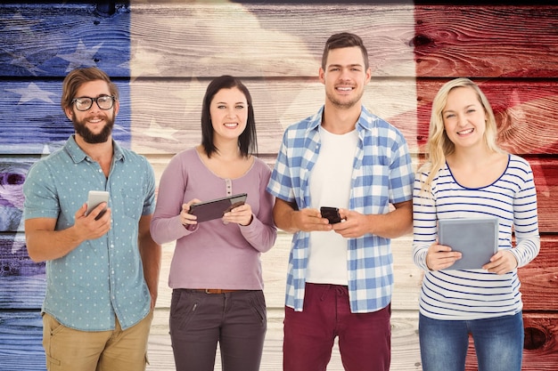 Composite image of portrait of smiling business people using electronic gadgets