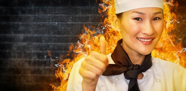 親指を立てる笑顔の女性料理人の肖像画の合成画像