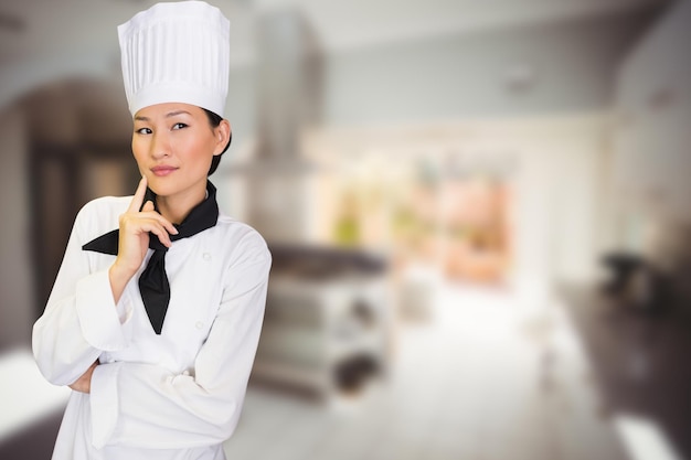 Composite image of portrait of thoughtful female cook in kitchen