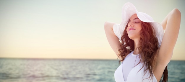 Composite image of portrait of women wearing a hat in summer