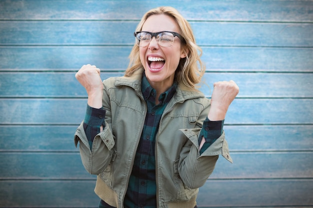 Composite image of pretty blonde cheering