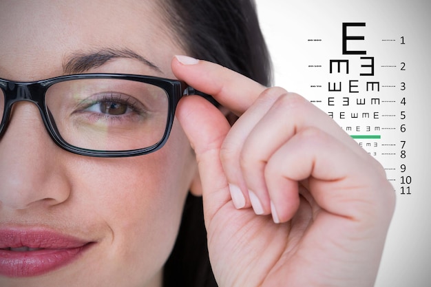 Composite image of pretty brunette wearing eye glasses