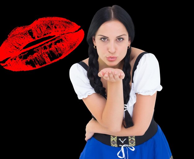 Composite image of pretty oktoberfest girl blowing a kiss