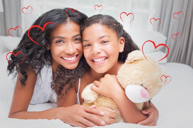 Photo composite image of pretty woman lying on bed with her daughter smiling at camera