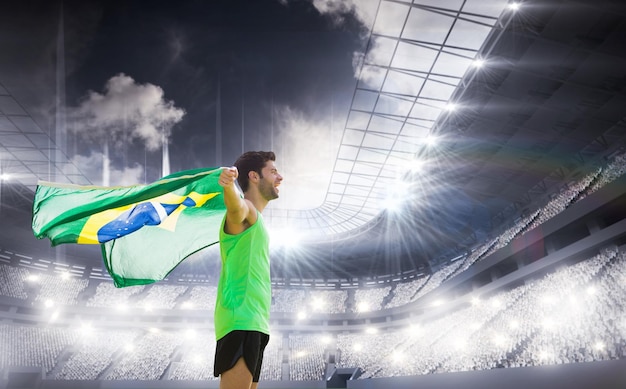 Composite image of profile view of brazilian sportsman is holding a flag