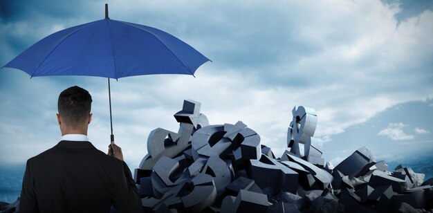 Composite image of rear view of businessman carrying blue umbrella